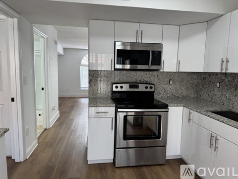 A kitchen with a stove top oven and microwave above it.