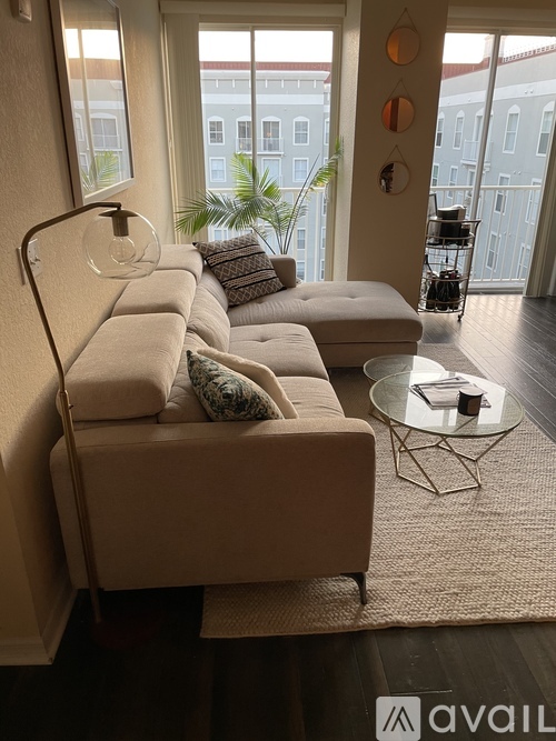 A living room with a couch, a chair, and a table.