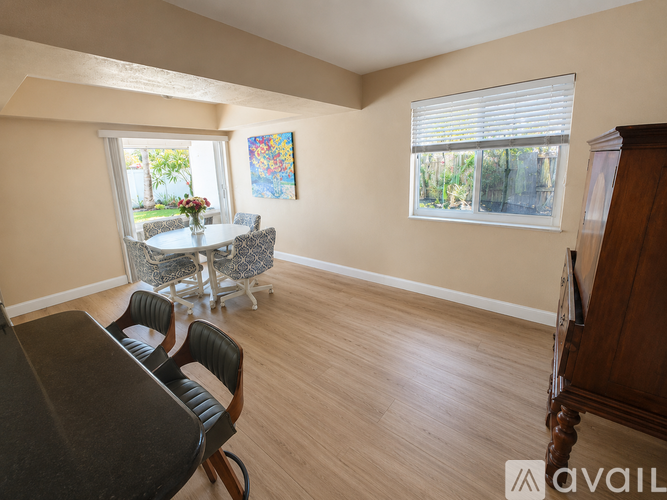 A dining room with a table and chairs.