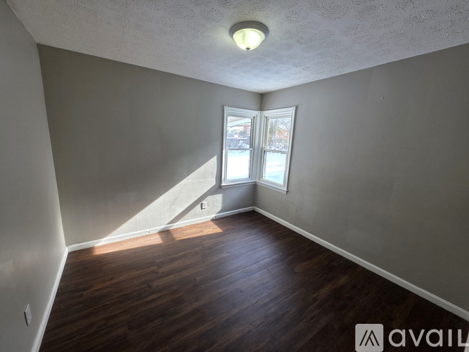 A room with wooden floors and a window.