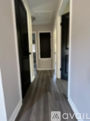 A long hallway with a door at the end.