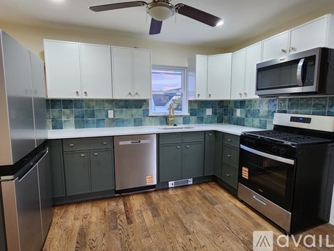 A kitchen with a black oven and white cabinets.