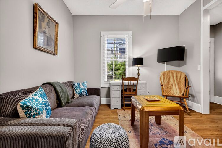 A living room with a brown couch and a wooden coffee table.