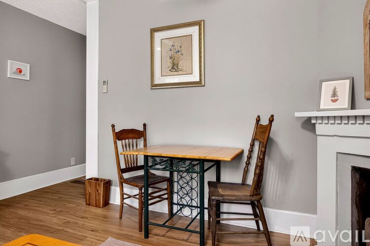 A dining room with a table and chairs.