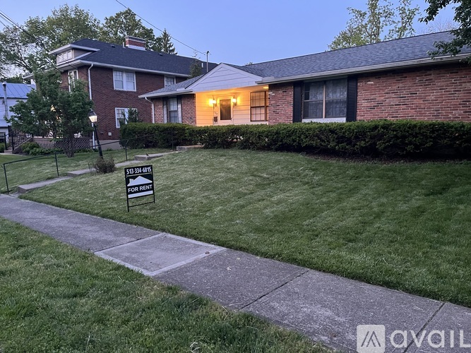 A house with a for sale sign in front of it.