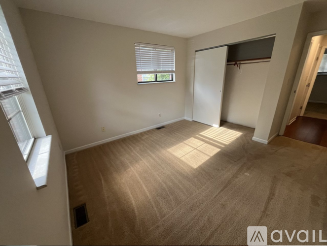 A room with a window and a door is available for rent.