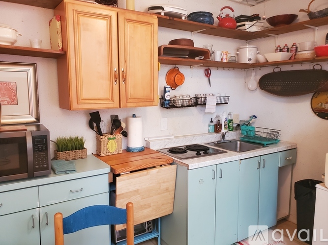 A kitchen with wooden cabinets and blue drawers.