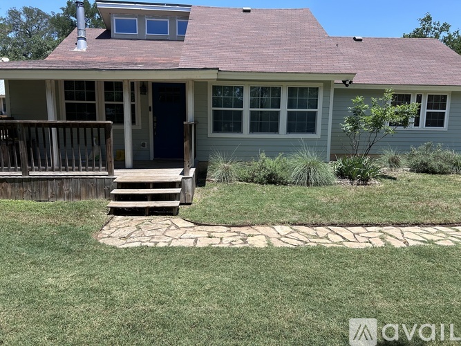 A house with a blue door and a small porch.