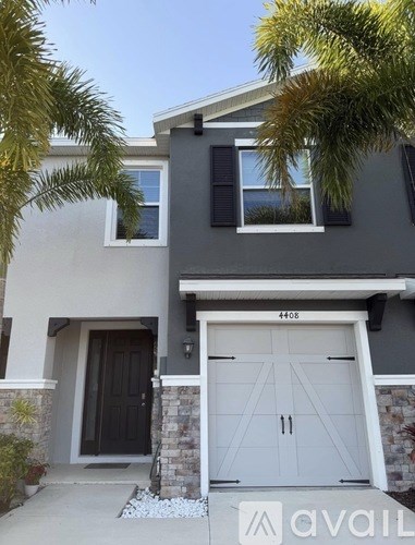 A modern house with a black door and a white garage door.