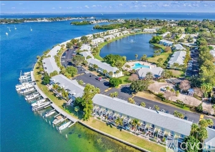 A marina with boats and a residential area with a pool.