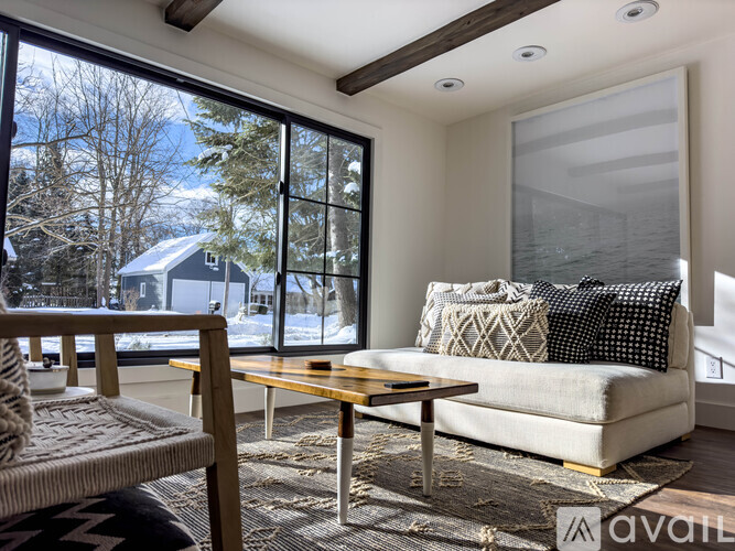 A living room with a couch, a chair, and a coffee table.