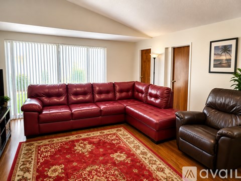 A red leather sectional sofa in a living room.