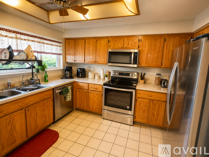 A kitchen with wooden cabinets and stainless steel appliances.