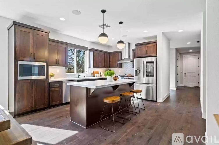 A modern kitchen with wooden cabinets and a central island.
