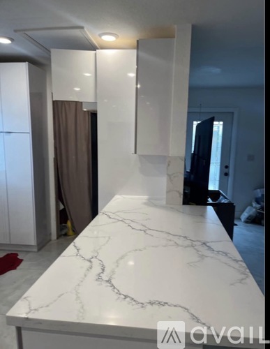 A white marble countertop with a black line running through it.