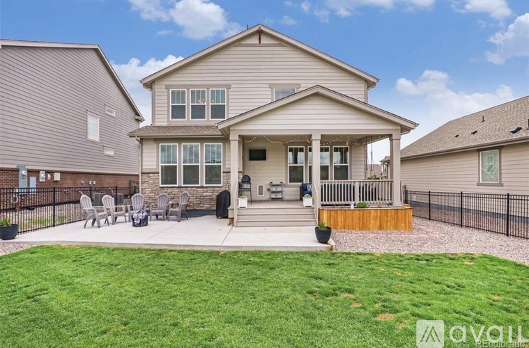 A house with a front porch and a lawn.