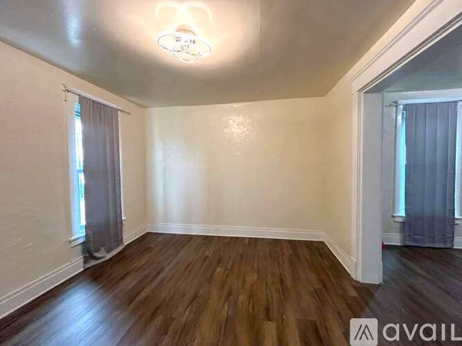 A room with wooden floors and white walls.