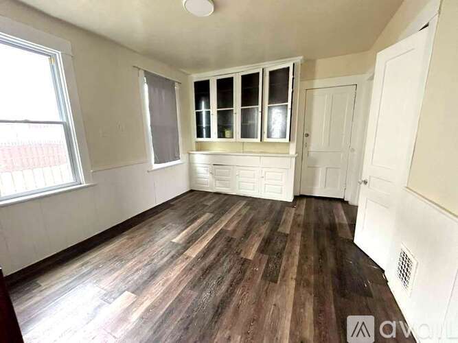 A room with wooden floors and white walls.