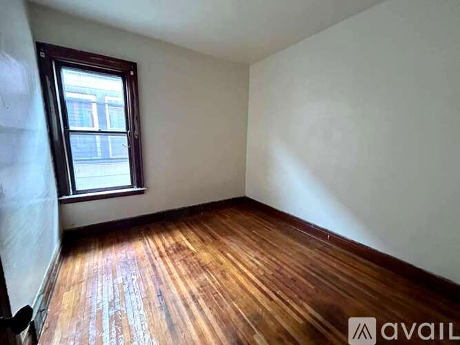 A room with wooden floors and a window.