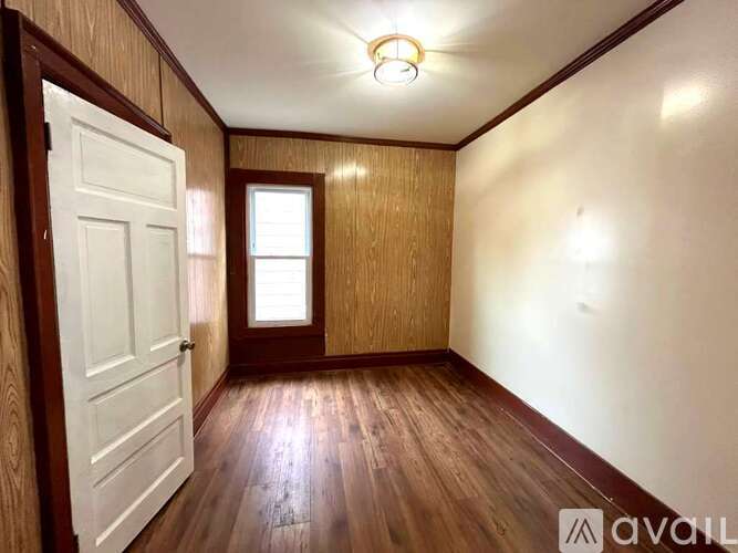 A room with wooden floors and a white door.