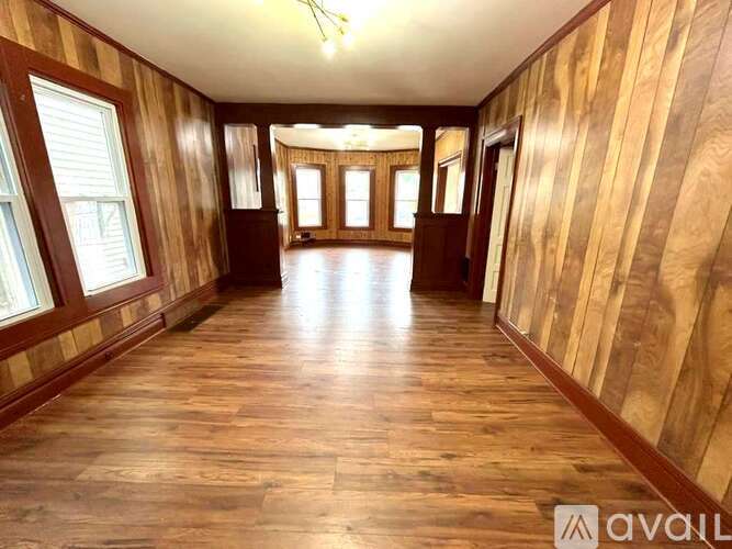 A long hallway with wooden floors and walls.