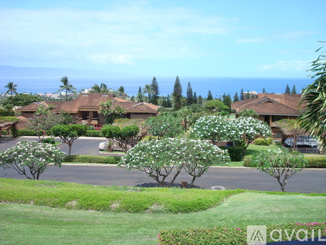 A row of houses with trees in front of them.