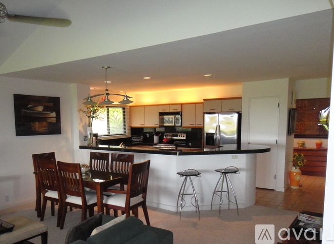A kitchen with a bar and a dining table.