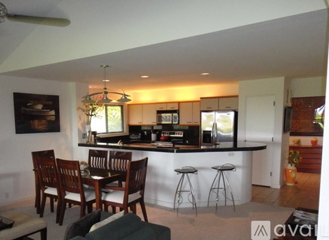 A kitchen with a bar and a dining table.