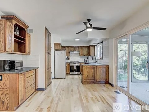 A kitchen with wooden cabinets and a white refrigerator.