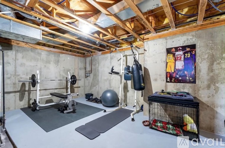 A home gym with a basketball poster on the wall.