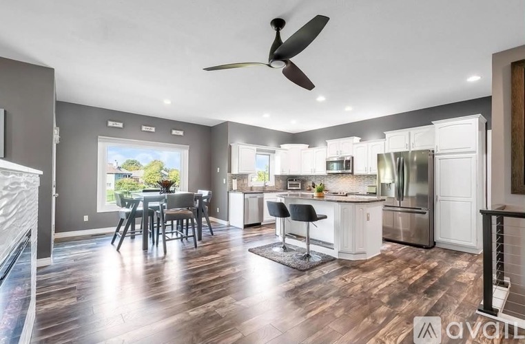 A modern kitchen with a dining table and chairs.