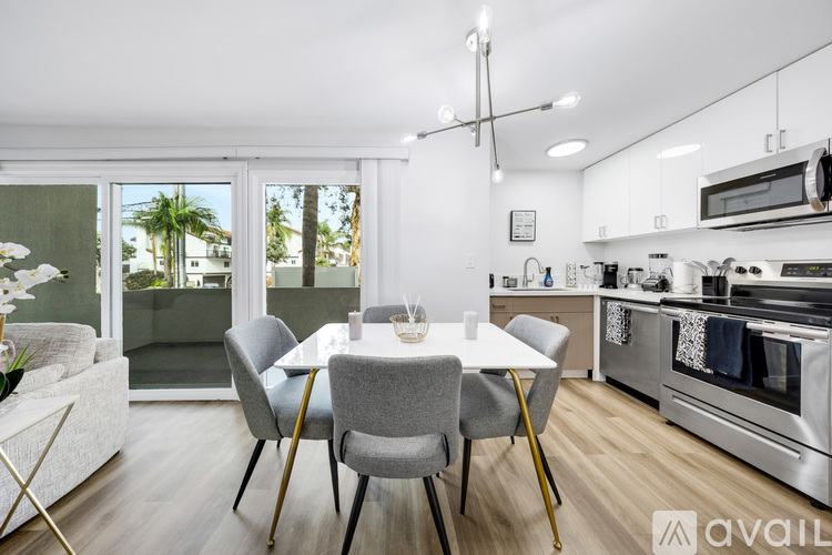 A modern kitchen with a dining table set for four.