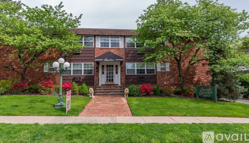 A brick building with a green lawn in front.