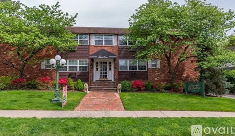 A brick building with a green lawn in front.