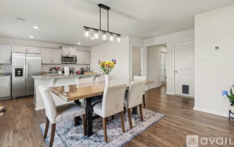 A modern kitchen with a dining table set for four.