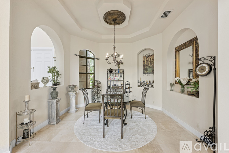 A dining room with a round table and chairs.