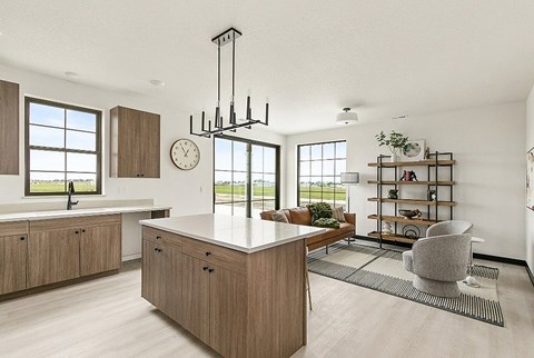 A modern kitchen with wooden cabinets and a large island.
