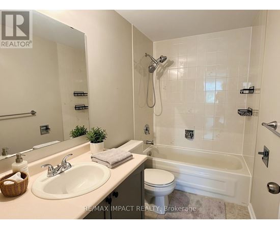 A bathroom with a white sink, toilet, and bathtub.