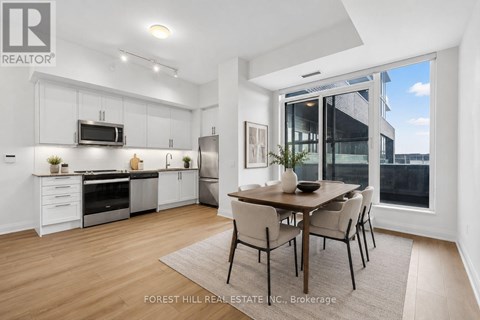 A modern kitchen with a dining table and chairs.
