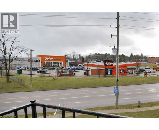 A view of a street with a Zehrs store and a REALTOR sign.