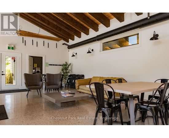 A dining room with a table and chairs.