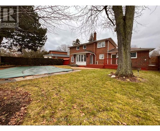 A house with a red brick exterior and a green lawn.