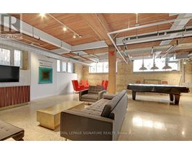 A large room with a pool table and couches.