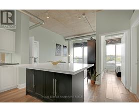 A kitchen with a white counter top and black cabinets.