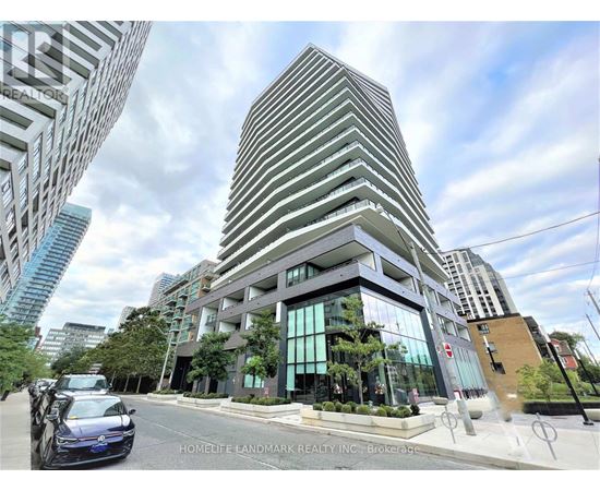 A modern building with a glass facade is the focal point of the image.