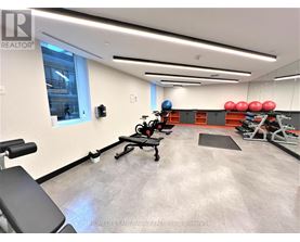 A gym with a row of red exercise balls on the wall.