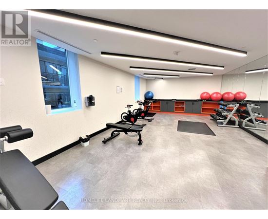 A gym with a row of red exercise balls on the wall.