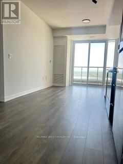 A room with a sliding glass door leading to a balcony.