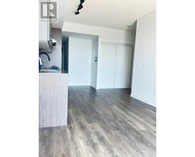 A room with a sink and a wooden floor.