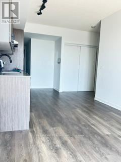 A room with a sink and a wooden floor.